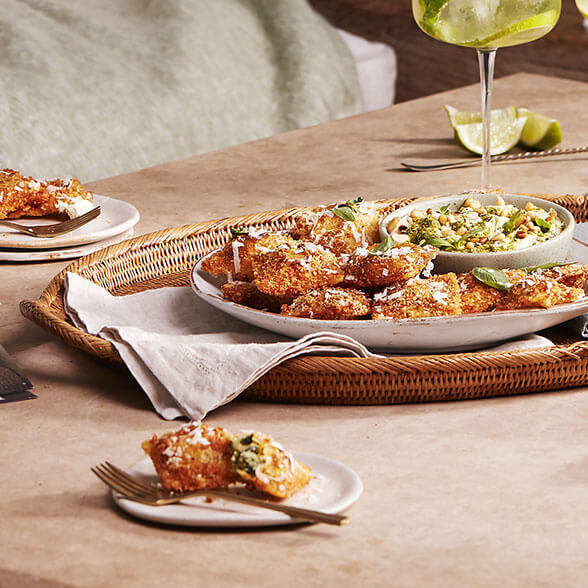 Crispy ravioli with creamy pesto dip