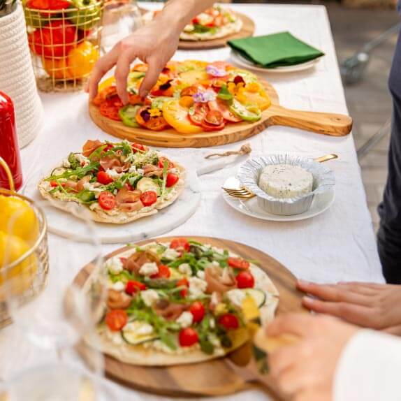 Freshly baked pizzas served on wooden serving boards